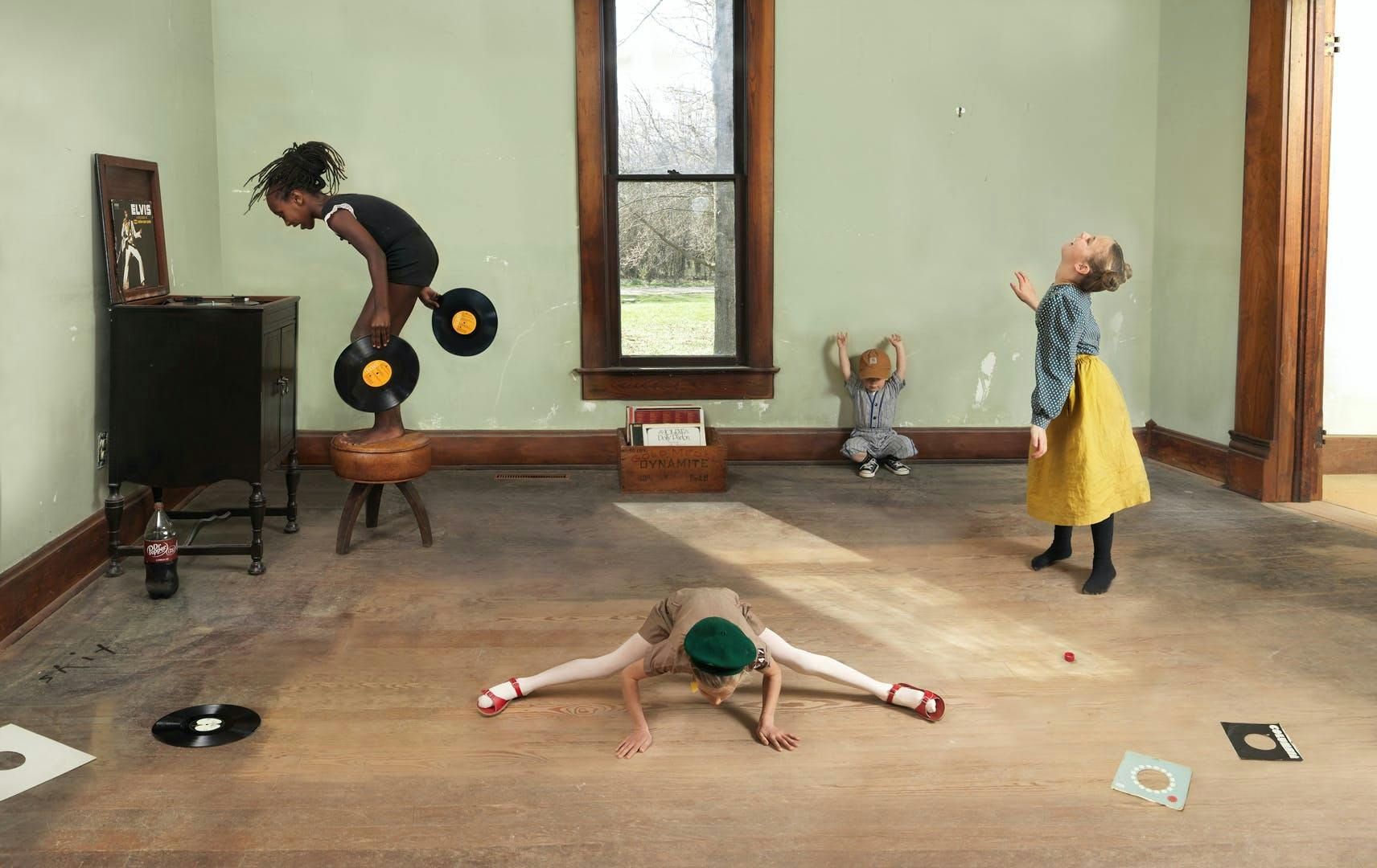 Photograph of children playing with records