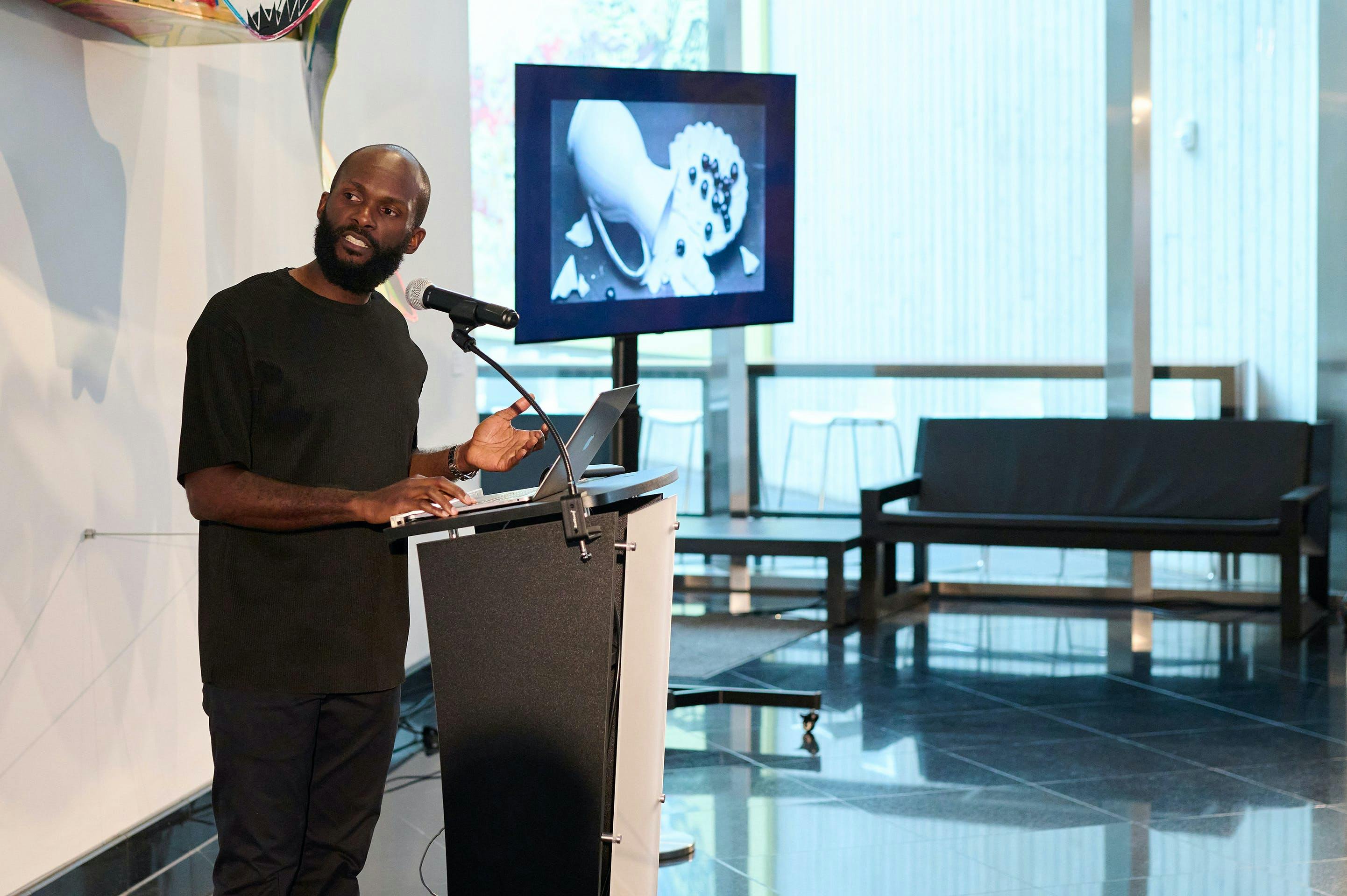 Photo of Paul Anthony Smith giving a talk at Kemper Museum
