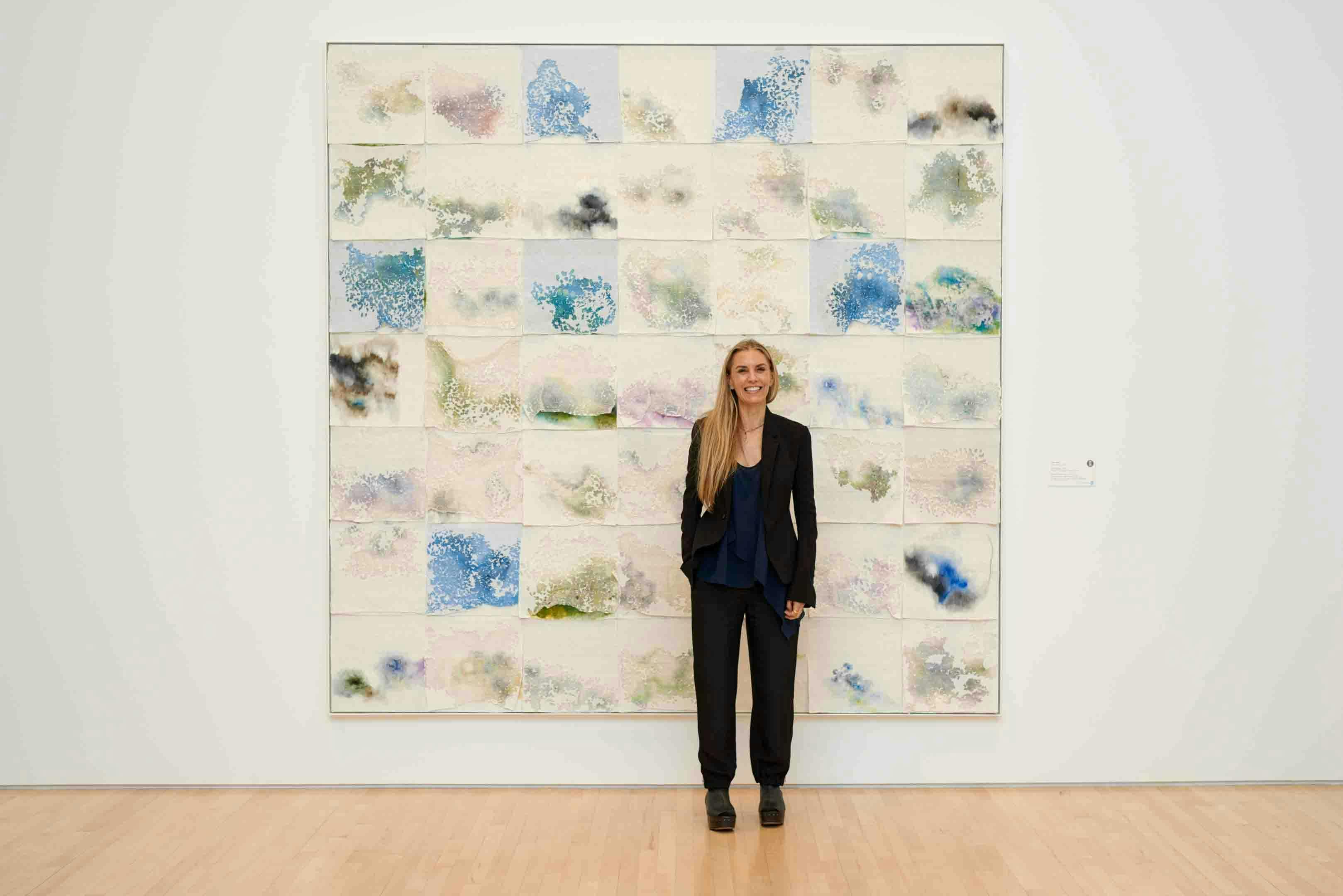 Artist Liza Lou standing in front of her artwork at Kemper Museum