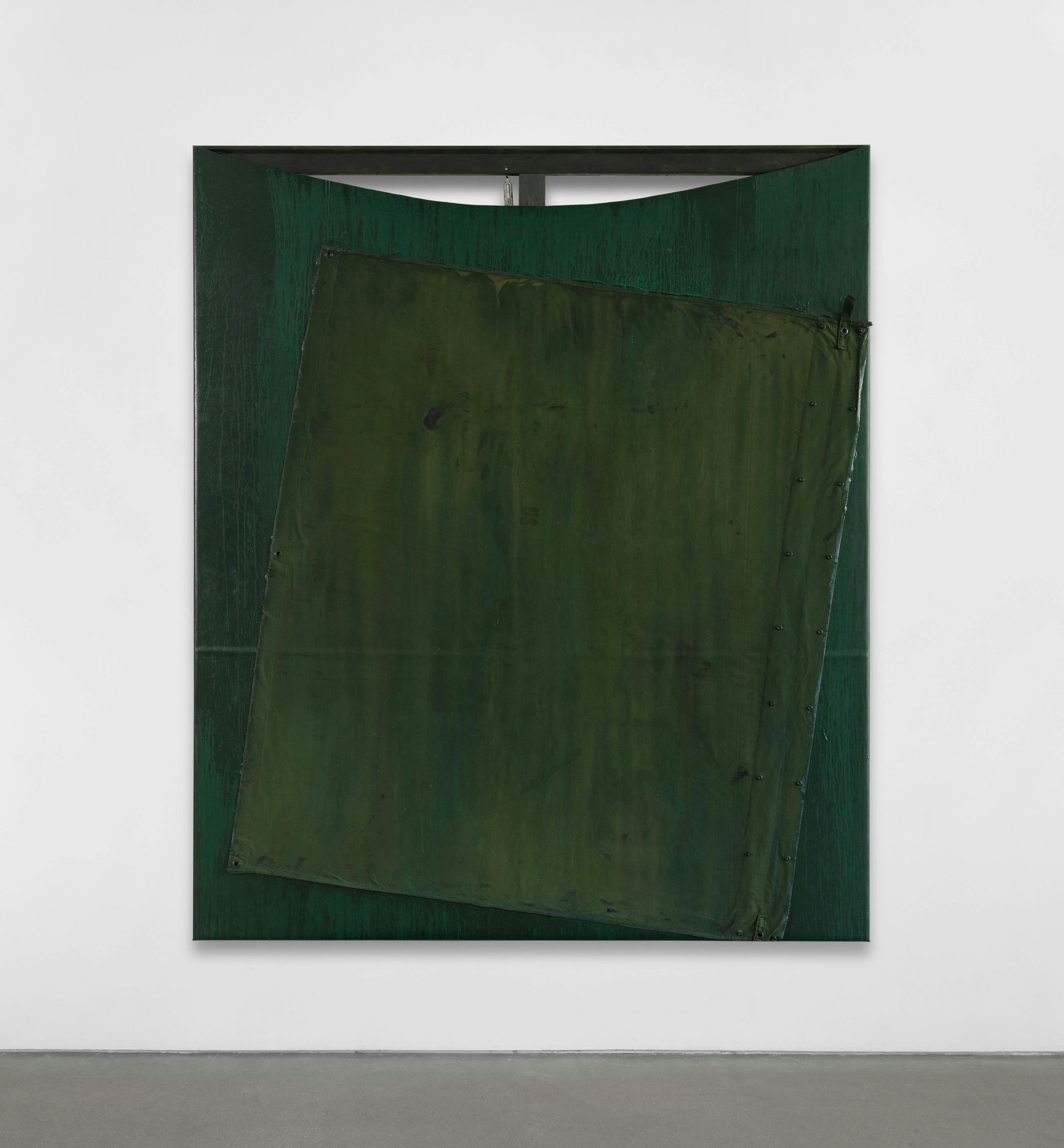 Green artwork by Reginald Sylvester II hanging on a white wall above a concrete floor.